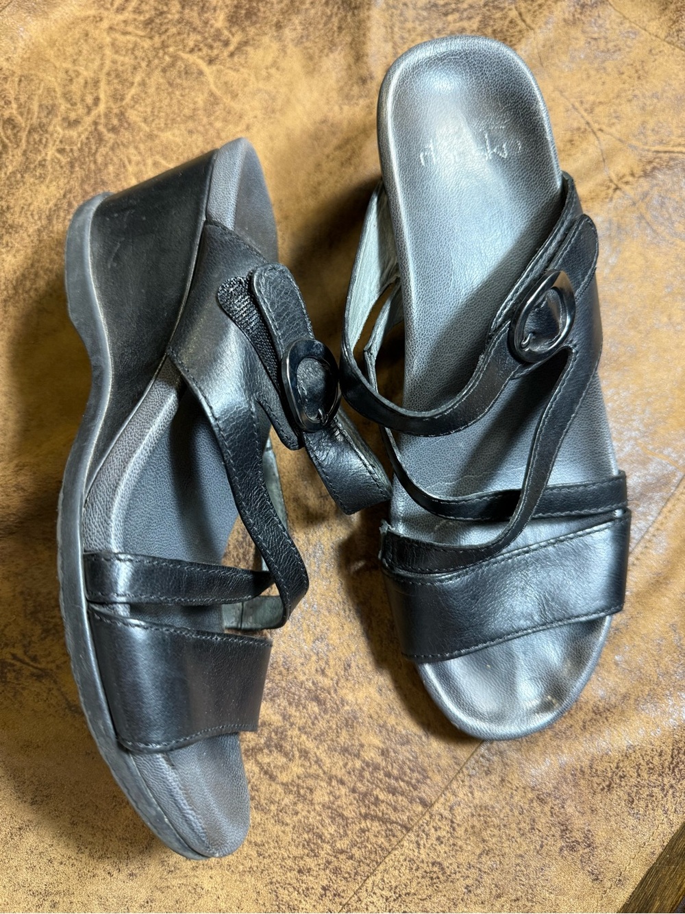 52. Dansko Black Leather Wedge Mules with Ring Accent